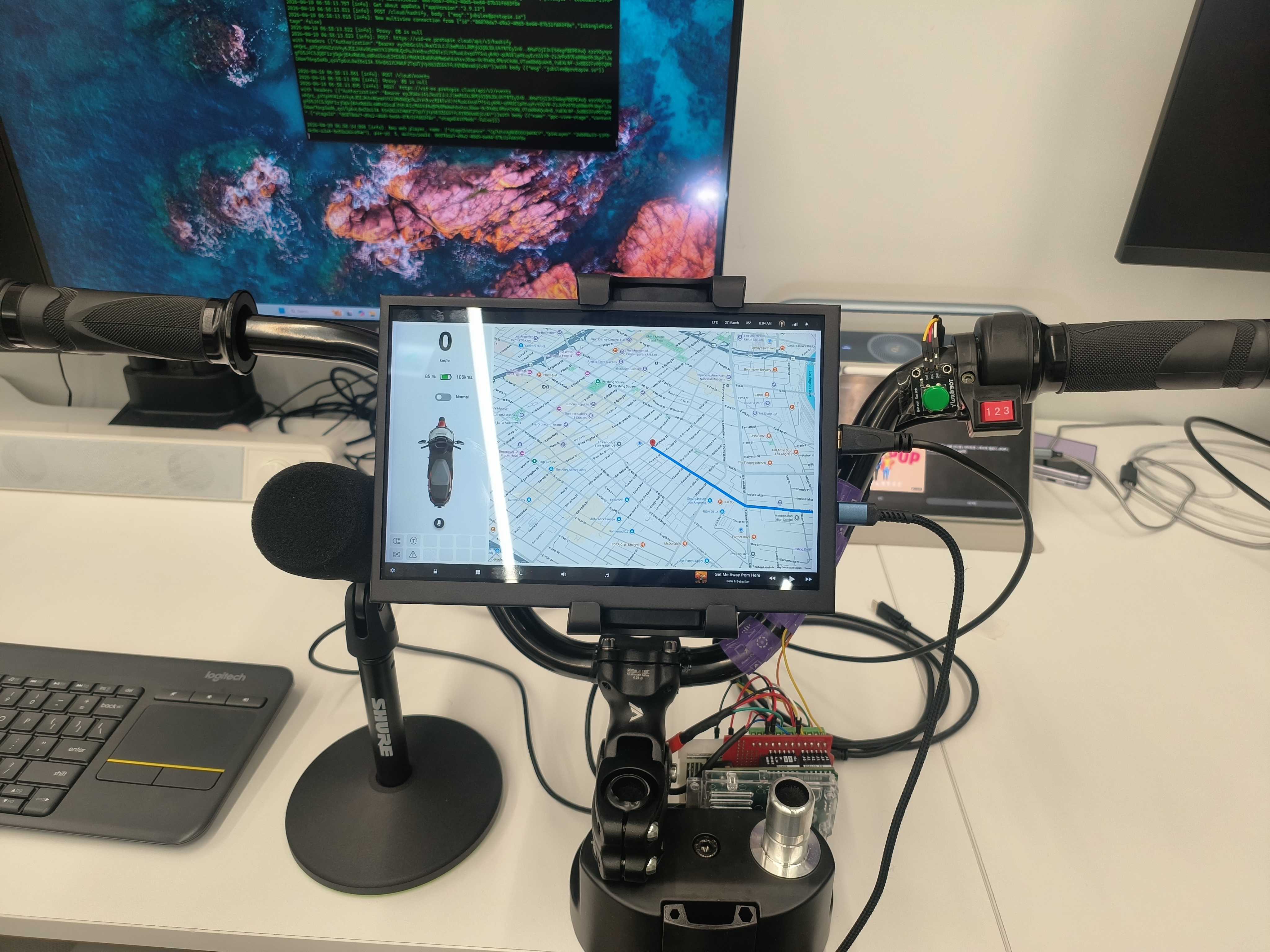 Fig. 1. Full e-scooter hardware bench rig with physical throttle, Arduino serial bridge, ProtoPie cluster, Google Maps API, and Gemini AI voice assistance.